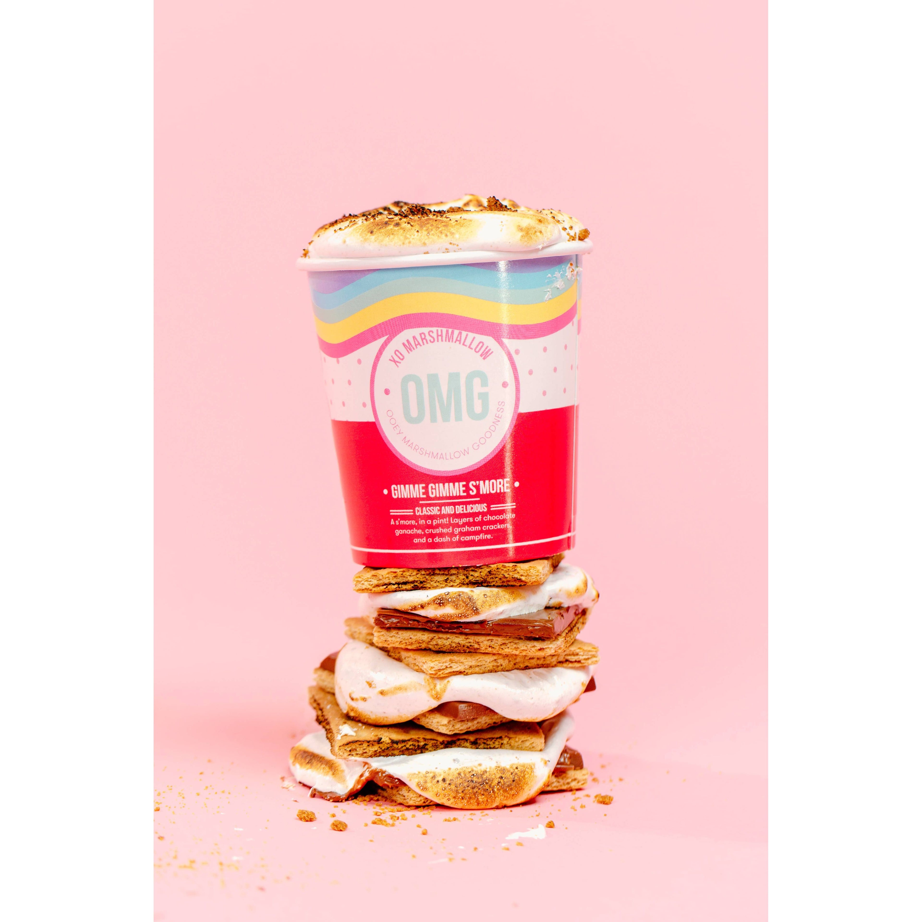Stack of marshmallow cookies with a colorful packaging on a pink background